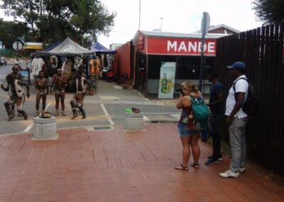 Part of a tour group watching the Batswana traditional dancers in Vilakazi Street, Soweto with Tourist Guide Sibusiso Mhlanga