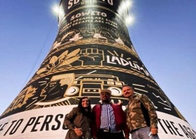 Guests with with Tourist Guide Sibusiso Mhlanga in front of the old Orlando Power Station Towers